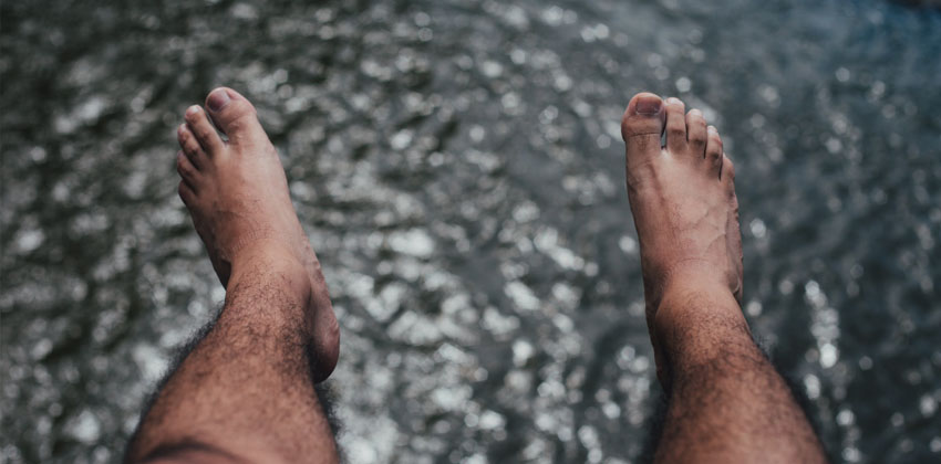 male pedicures - man feet over water